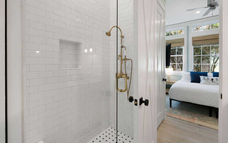 Step into your spa-like shower with gleaming white subway tiles and elegant brass fixtures.