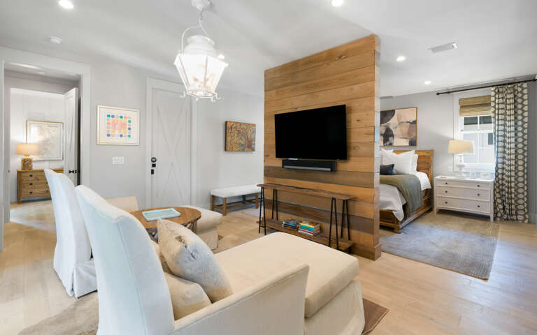 Relax in your elegant suite where warm wood accents and plush seating create the perfect retreat for unwinding after exploring.