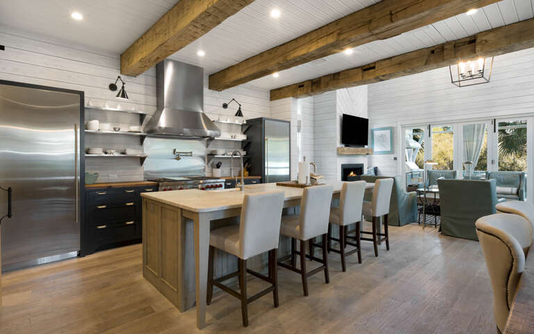 You'll love cooking in this stunning gourmet kitchen featuring exposed beams, premium appliances, and island seating for memorable meals together.