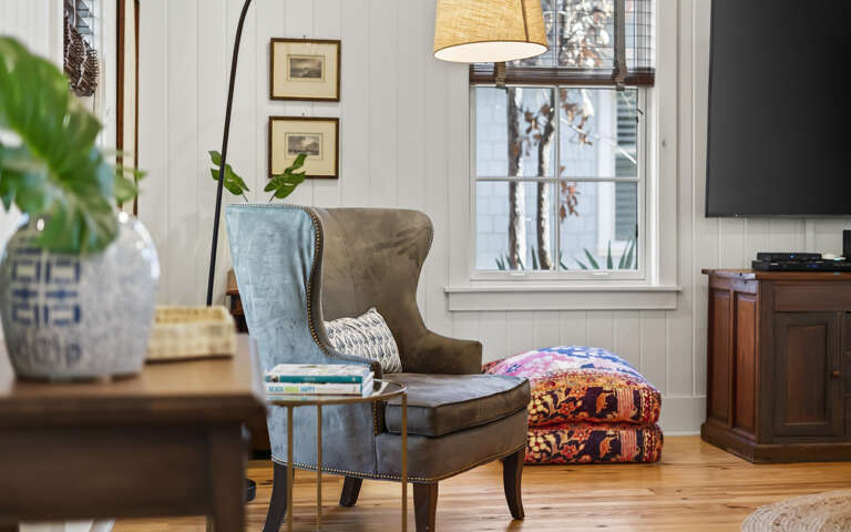Curl up in your cozy reading nook with a plush wingback chair, warm lighting, and peaceful garden views.