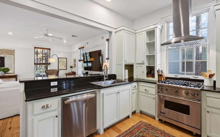 Your gourmet kitchen awaits with gleaming granite counters, professional-grade appliances, and elegant white cabinetry for inspired home cooking.