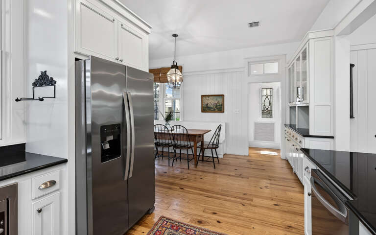 Your gourmet kitchen awaits with gleaming stainless appliances and rich hardwood floors, perfect for preparing memorable meals.