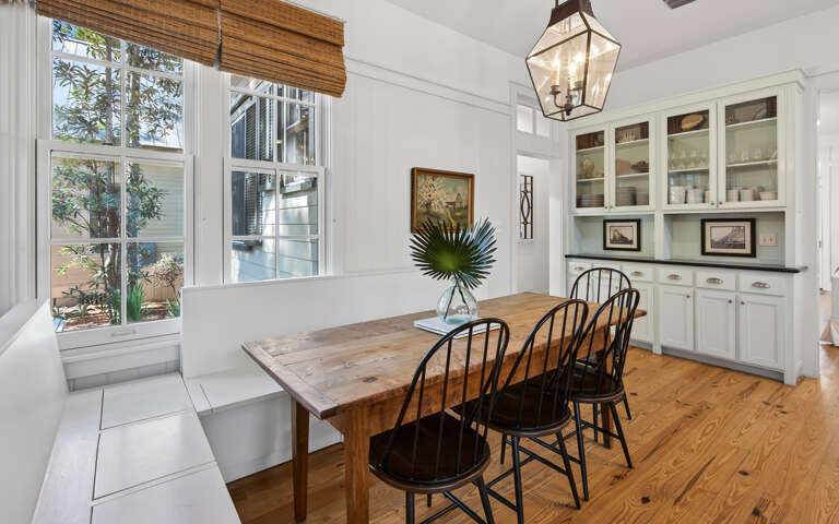 Gather around this rustic wooden dining table where your group can share memorable meals in this bright, welcoming space with built-in storage.