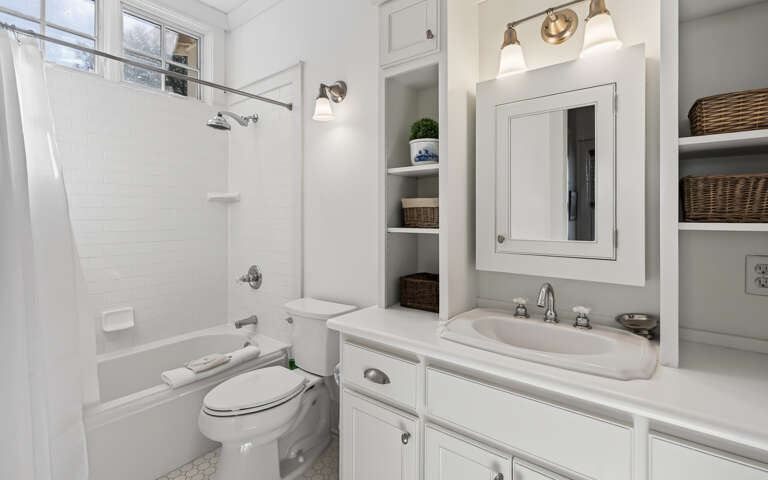 Unwind in your bright bathroom featuring a soaking tub, rainfall shower, and custom storage for all your essentials.