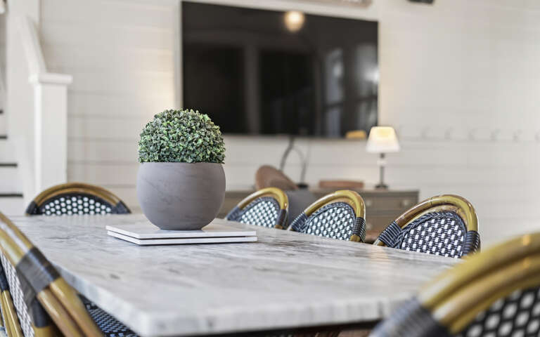 Gather around this elegant marble dining table where memorable meals and conversations await you.