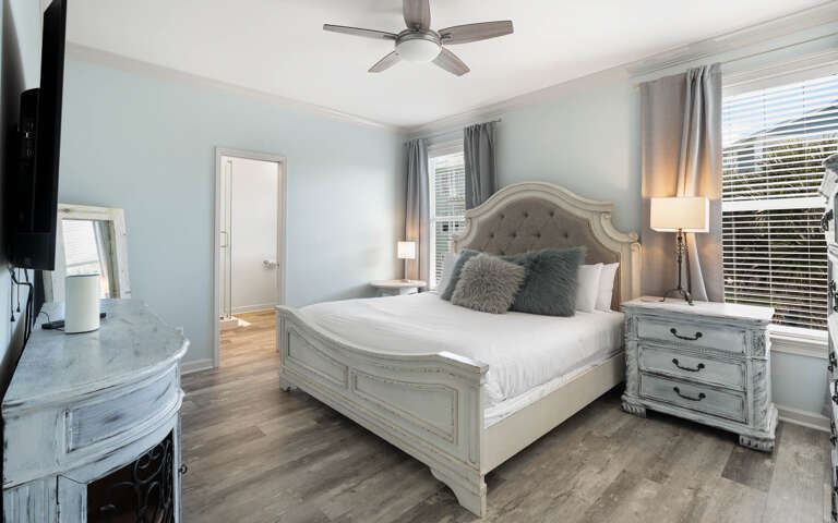 Step into your serene bedroom sanctuary with elegant furnishings, plush bedding, and soft blue walls creating the perfect retreat for restful nights.