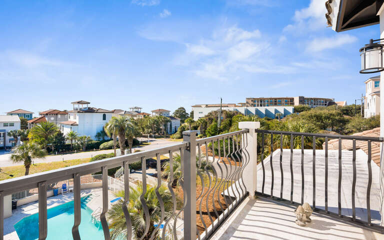 Step onto your private balcony for stunning pool and neighborhood views under endless blue skies.