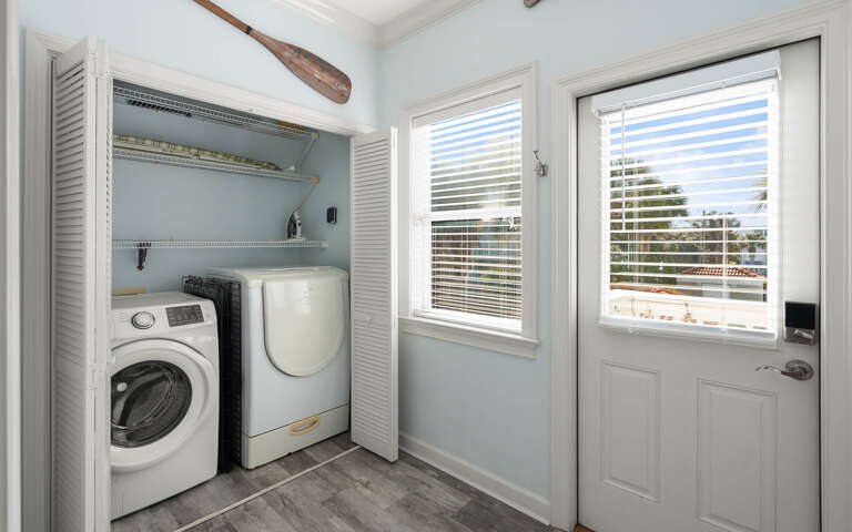 Your dedicated laundry space features full-size washer and dryer with organized storage shelving for effortless upkeep during your stay.
