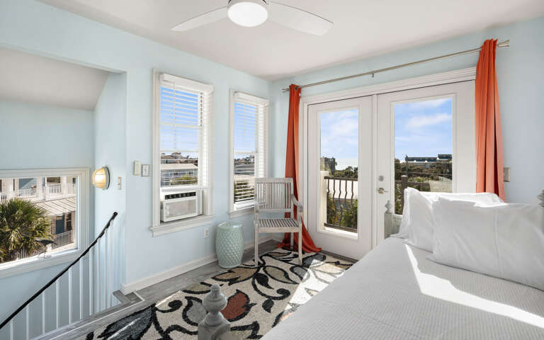 Wake up to stunning views from your bright bedroom with French doors opening to a private balcony overlooking the coastal landscape.