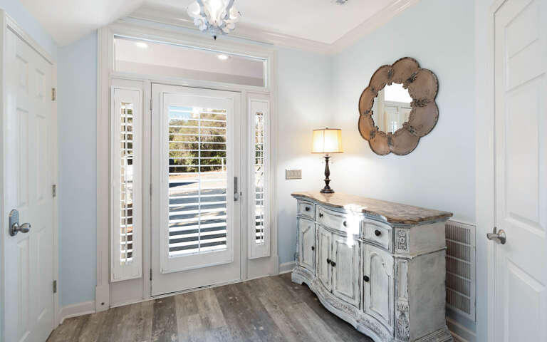 Step into your elegant entry foyer with coastal charm and vintage touches that welcome you home.