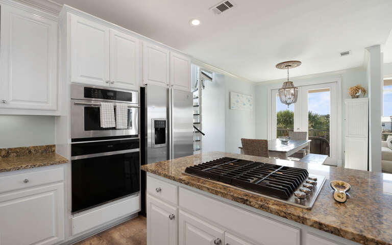 Your gourmet kitchen awaits with granite counters, stainless appliances, and gas cooktop - perfect for creating memorable meals together.