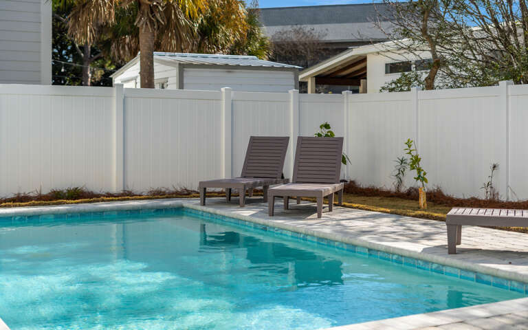 Soak up sunshine on your private poolside loungers, surrounded by tropical palms and complete privacy.