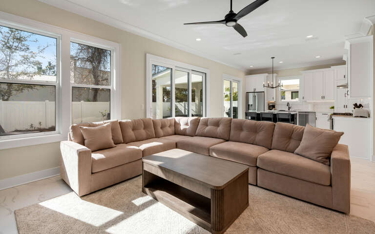Unwind in this bright, open living space with plush sectional seating and modern kitchen just steps away for your convenience.