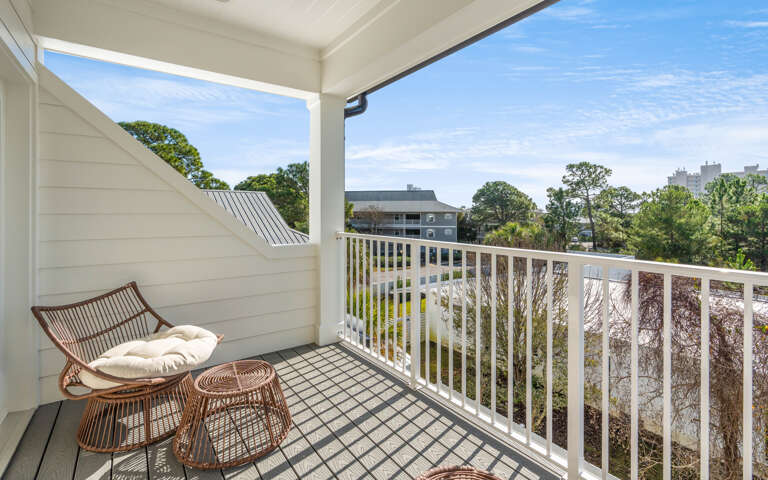 Your private balcony offers peaceful moments with wicker seating overlooking neighborhood views. Relax with morning coffee while enjoying fresh air.