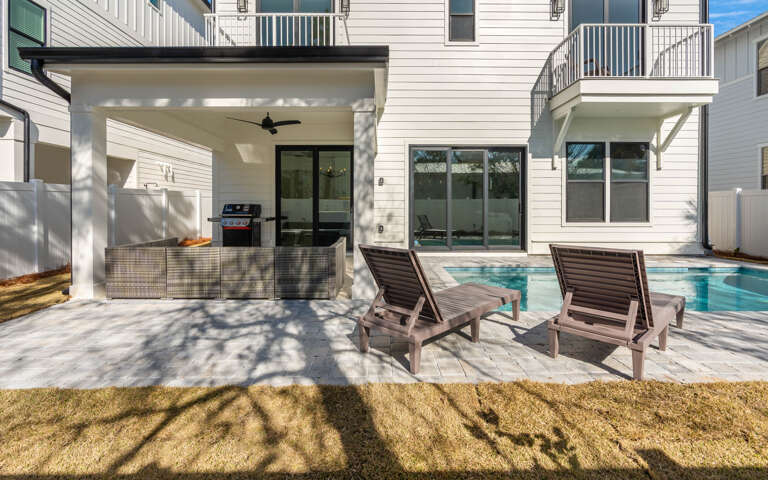 Relax poolside on comfortable loungers while your BBQ sizzles under the covered pavilion—your perfect outdoor retreat awaits.