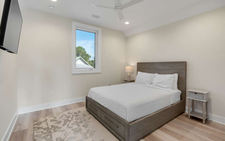 Your peaceful bedroom features crisp white linens and modern furnishings, creating the perfect retreat for restful nights.