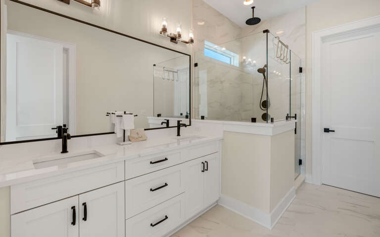 Indulge in your private spa-like retreat with elegant marble finishes, rainfall shower, and luxurious dual vanities for your daily pampering.