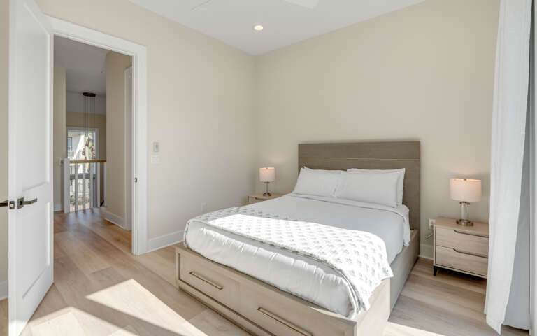 Your serene bedroom sanctuary awaits with crisp linens, warm bedside lighting, and contemporary comfort for the perfect night's rest.