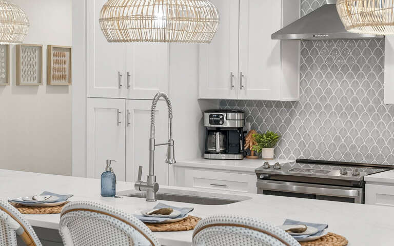 Your bright kitchen features modern appliances and elegant pendant lighting, perfect for preparing meals together.