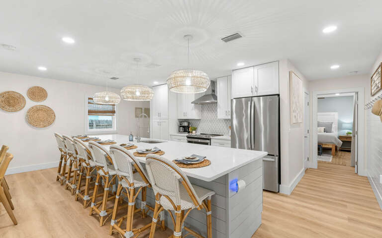 Your chef-style kitchen features elegant pendant lighting and spacious island seating for memorable group meals together.