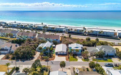 Stunning beachfront location with pristine white sand and turquoise waters just steps from your vacation home.