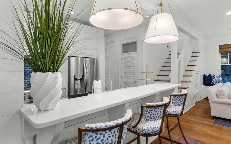 Your bright open kitchen invites morning coffee conversations at the sleek breakfast bar, while stainless appliances await your culinary adventures.