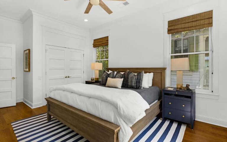 Drift off to sleep in your cozy bedroom featuring crisp white linens, wood accents, and charming nautical touches.