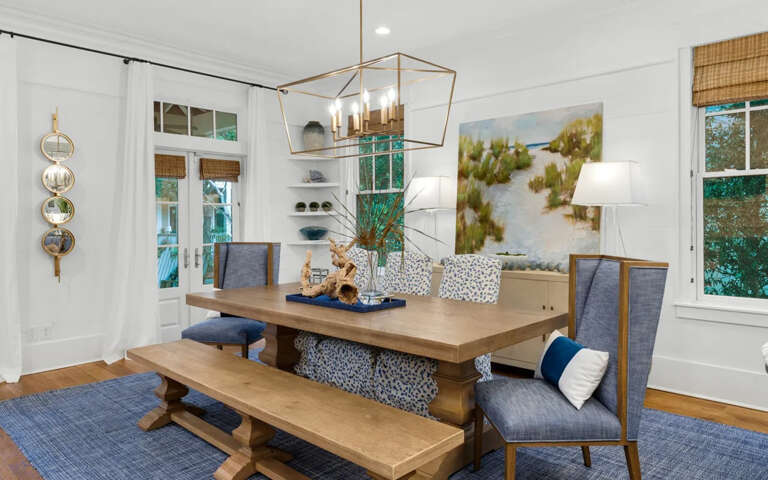 Gather around your elegant dining table where natural light streams through windows, creating the perfect setting for memorable meals together.