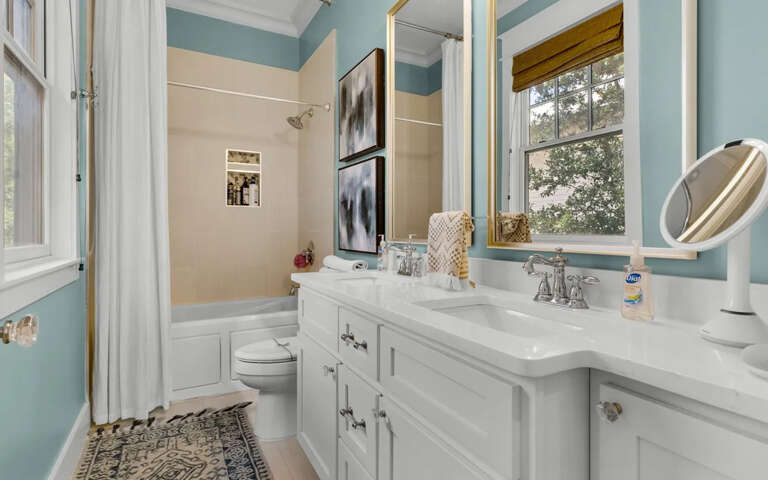 Your private bathroom features dual vanities with elegant marble countertops and a relaxing tub-shower combo for unwinding after busy days.