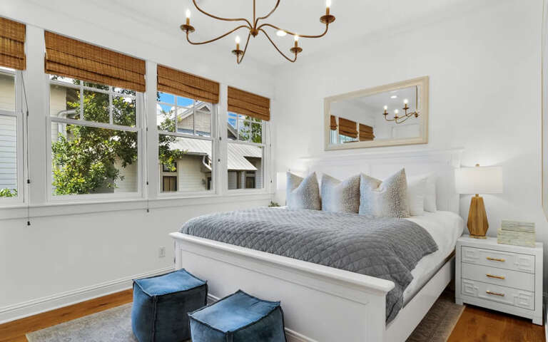 Slip into crisp white linens and cozy gray throws in your bright bedroom, where morning light filters through bamboo shades.