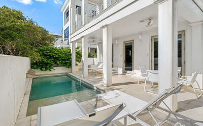 Dive into your private oasis with a stunning pool surrounded by stylish loungers and covered terrace seating.