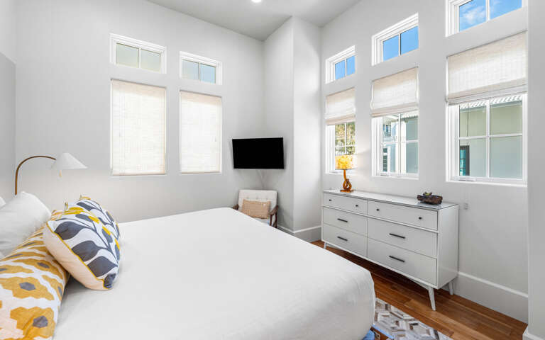 Drift off to sleep in your bright, airy bedroom with fresh linens and mountain views through tall windows.