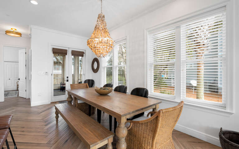Gather around this elegant dining space where a stunning chandelier creates warm ambiance for memorable meals with loved ones.