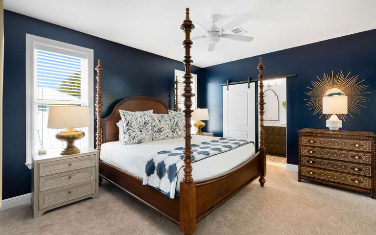 Sleep peacefully in your elegant four-poster bed surrounded by rich navy walls and thoughtful furnishings that create the perfect retreat.