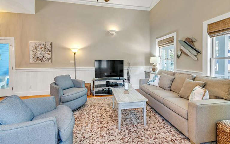 Relax in your spacious living room with plush seating, warm lighting, and modern entertainment setupâperfect for cozy evenings after exploring.