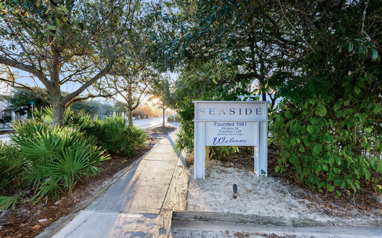 Welcome sign marks your arrival at this charming Seaside community, established in 1981 and nestled among lush tropical landscaping.