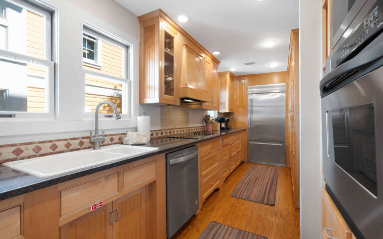 Your fully equipped kitchen features beautiful wood cabinetry, modern stainless appliances, and everything you need to create memorable meals together.
