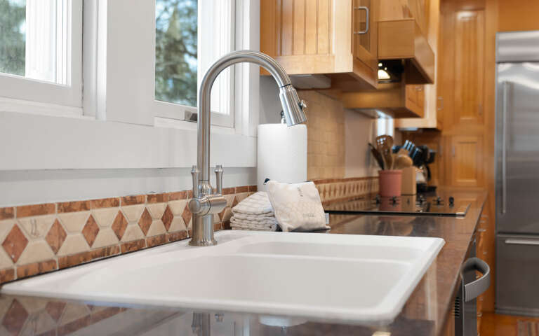 Your fully equipped kitchen features a pull-down faucet, quality appliances, and warm wood cabinetryâperfect for preparing memorable meals.