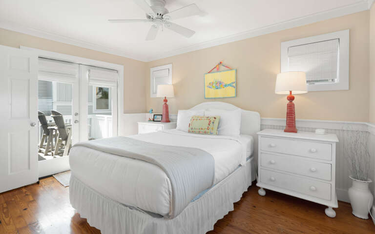 Wake up refreshed in your peaceful bedroom with coastal charm, complete with a ceiling fan and French doors opening to your private balcony.