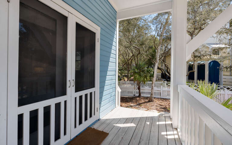 Your private entrance opens to a charming covered porch with peaceful garden views through mature trees.