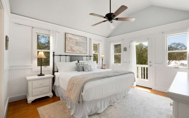 Drift into peaceful slumber in your airy bedroom with vaulted ceilings, gentle fan breeze, and French doors opening to your private balcony.