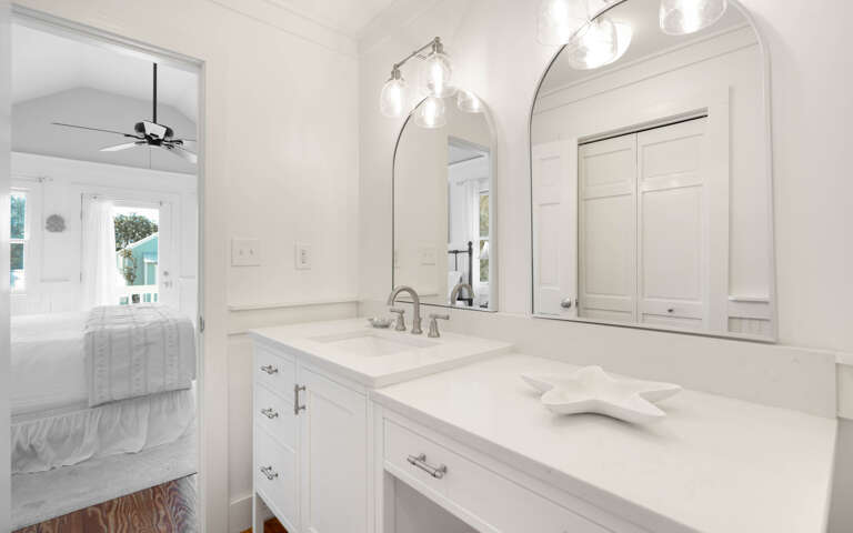 Step into your elegant ensuite bathroom with pristine marble counters and designer lighting for a luxurious morning routine.