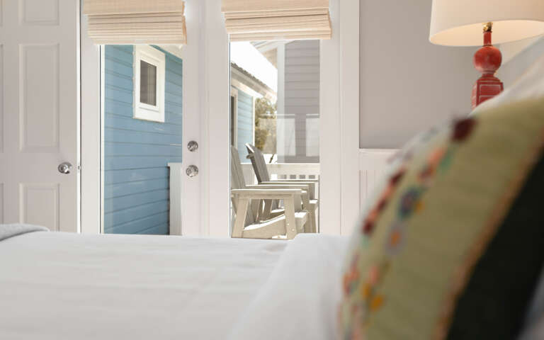 Wake up to peaceful mornings in your cozy bedroom, where soft linens and charming coastal views create the perfect seaside retreat.