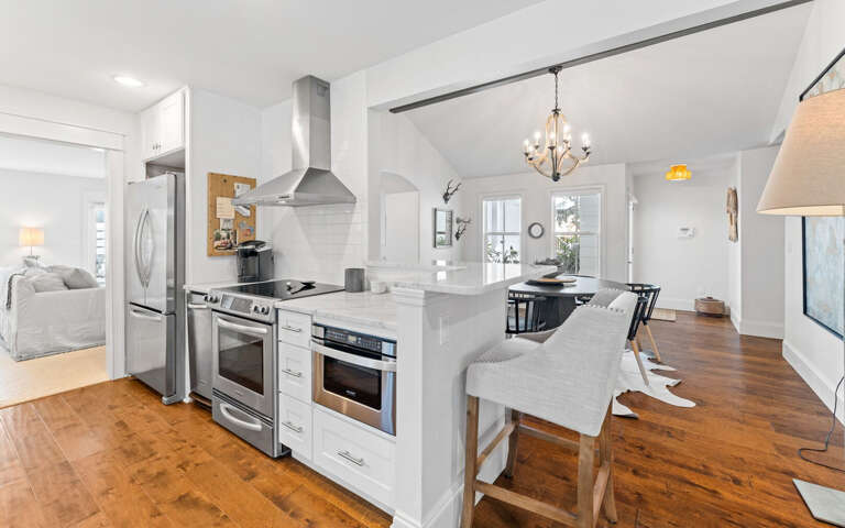 Step into your open-concept haven where the modern kitchen flows seamlessly into cozy living spaces, perfect for memorable meals together.