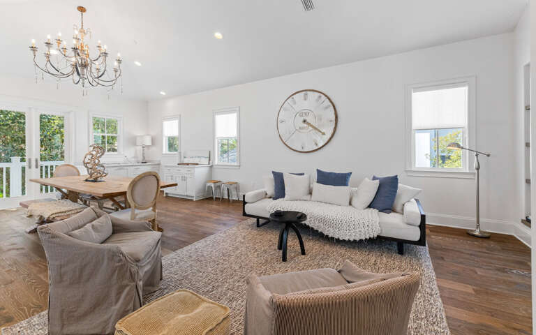 Unwind in this bright, elegant living space with plush seating and gleaming hardwood floors that invite barefoot comfort.