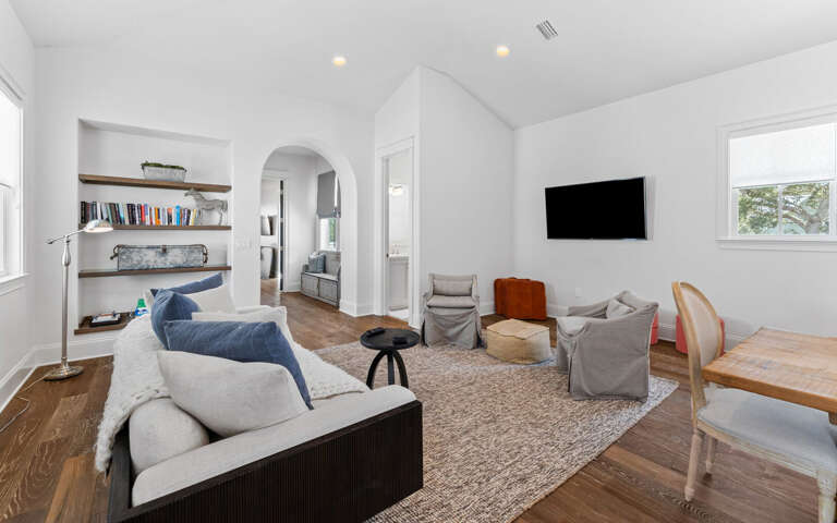 Unwind in your bright, thoughtfully designed living space with cozy seating, built-in shelving, and modern entertainmentâperfect for relaxing after exploring.