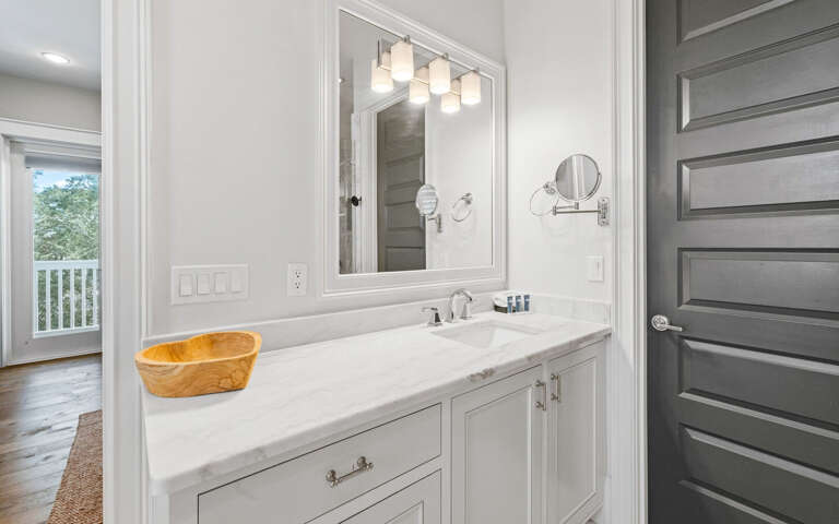 Unwind in your elegantly designed bathroom featuring marble counters and modern lighting perfect for your morning routine.