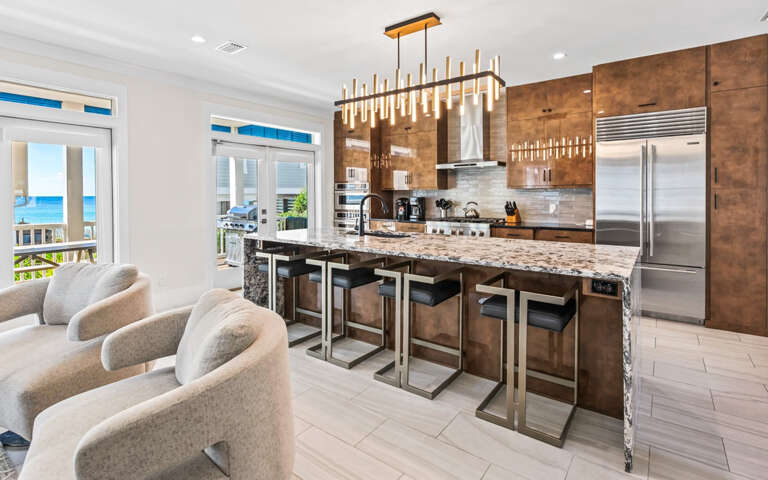 Your gourmet kitchen features stunning ocean views, premium appliances, and a spacious island perfect for cooking and entertaining together.