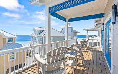 Relax on your private balcony with stunning ocean views, where comfortable seating invites you to unwind and soak in coastal tranquility.