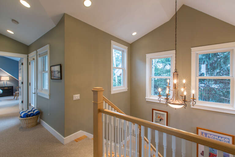 Second floor staircase leading to both master bedrooms and hot tub deck.
